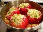 Four lovely red bell peppers, stuffed with breadcrumbs, herbs, and cheese.